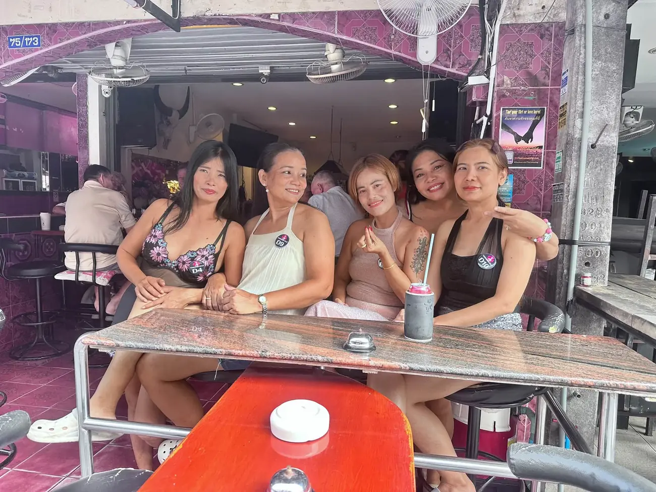 The Tordenskjold team sitting together at a marble table at the front of the bar
